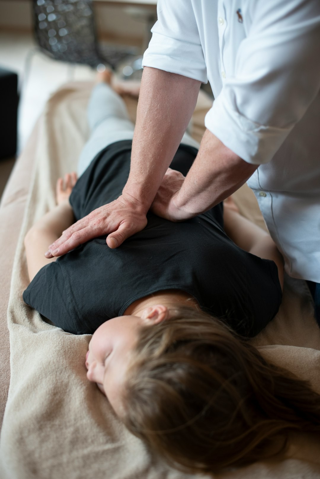 a woman getting a back massage from a man